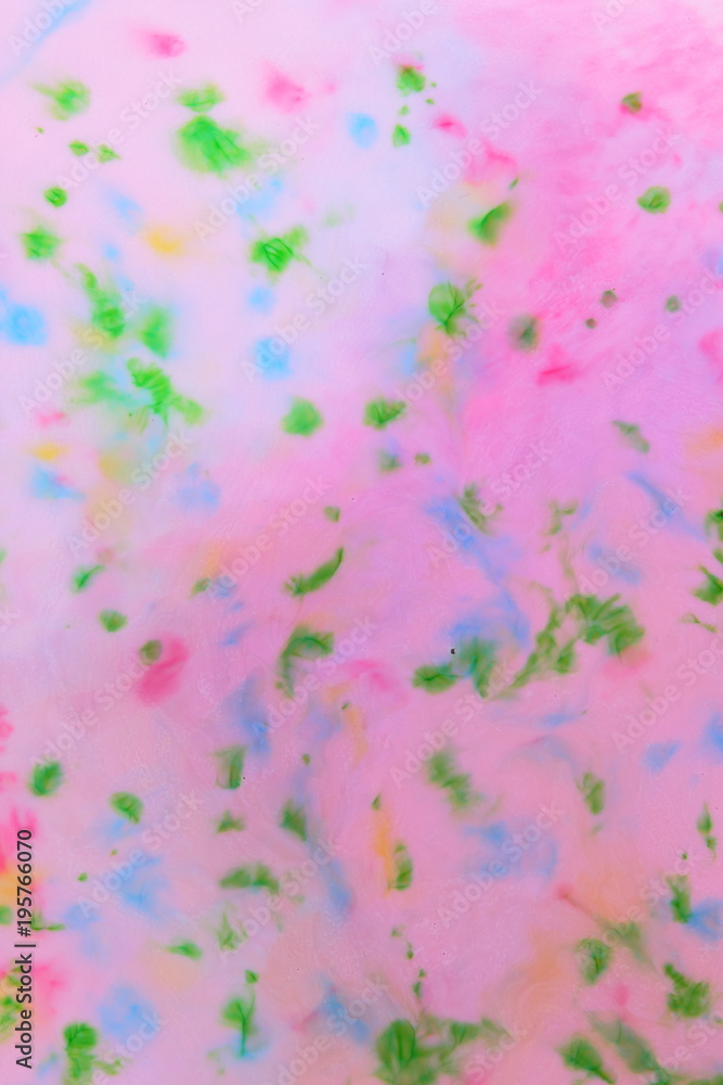 Multicolored pattern, colored spots on a pink background, abstract texture, minimalistic background, pop art blank for a designer, pattern for the design of fabric, multicolored stains on a liquid