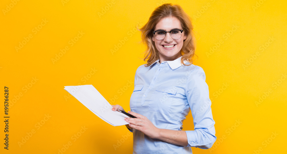 Blonde woman with blank paper and pen Blonde woman with blank paper and pen