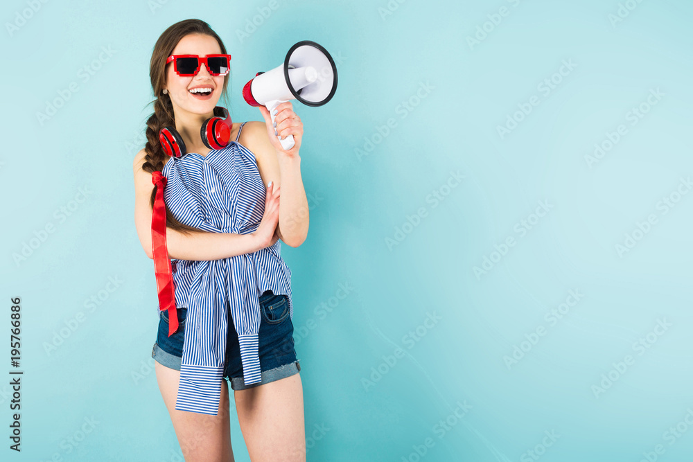Young sexy woman with headphones and loudspeaker Young sexy woman with headphones and loudspeaker