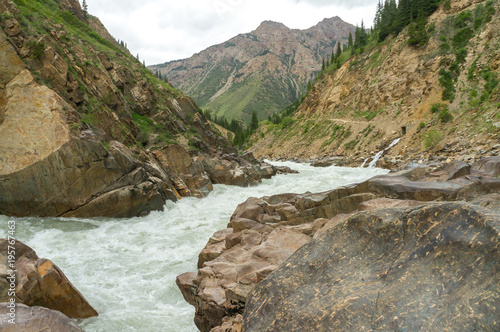 The Naryn River flows between huge boulders and rocks