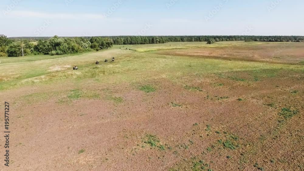 Aerial View Flying Green Area Showing ATV quad Riders Driving, tours for tourists, outdoor recreation, travel organization Aerial View Flying Green Area Showing ATV quad Riders Driving, tours for tourists, outdoor recreation, travel organization