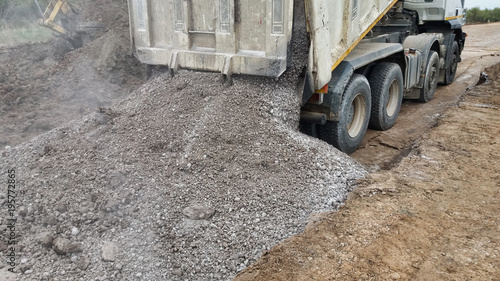 Fotografie, Obraz View of dump truck dumping gravel