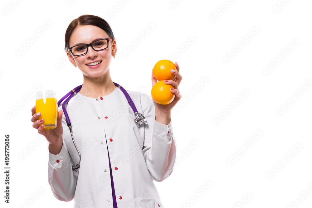 Female nutritionist hold oranges and glass of fresh juice in her hands on white background Female nutritionist hold oranges and glass of fresh juice in her hands on white background