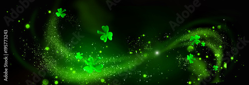 St. Patrick's Day. Green shamrock leaves over black background. Abstract holiday backdrop