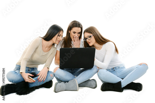 Three girls holding laptop
