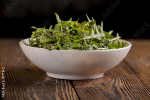 lemons and arugula on a wooden table photo