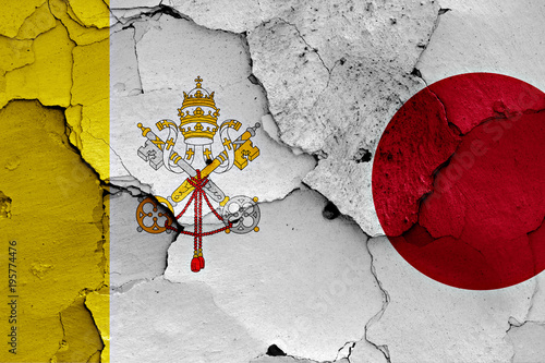 flag of Vatican and Japan painted on cracked wall