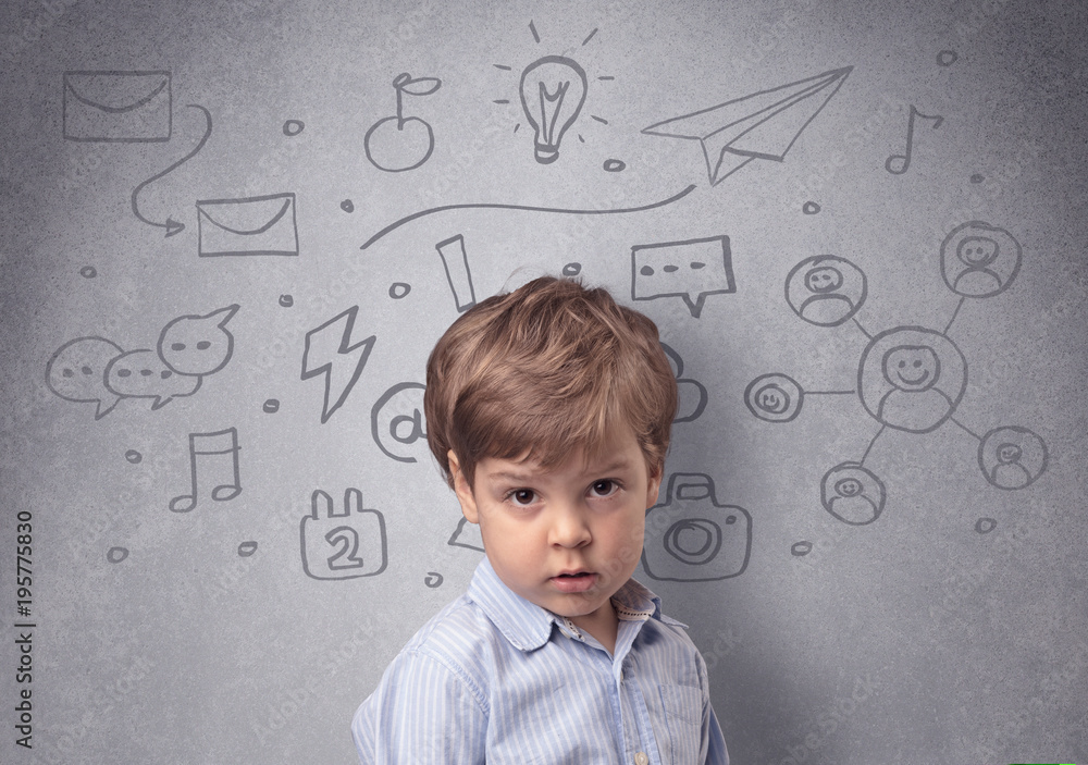 Smart kid in front of a drawn up grey wall