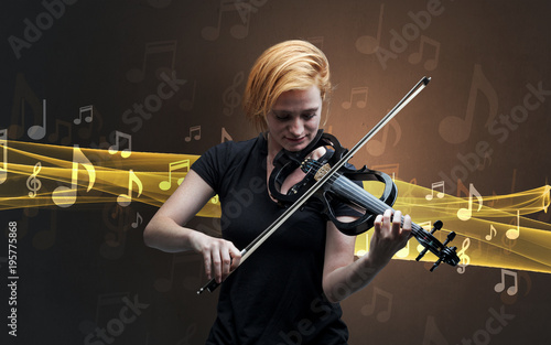 Musician playing on violin with notes around photo