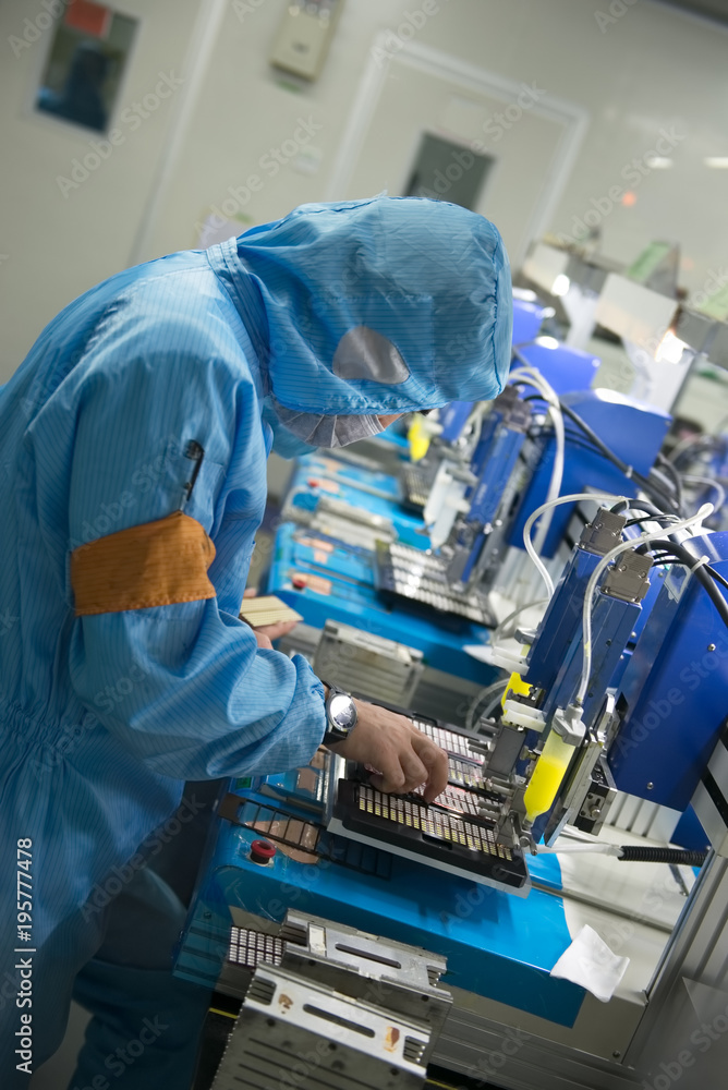 Worker of a Chinese LED production factory at work vertical photo Worker of a Chinese LED production factory at work vertical photo