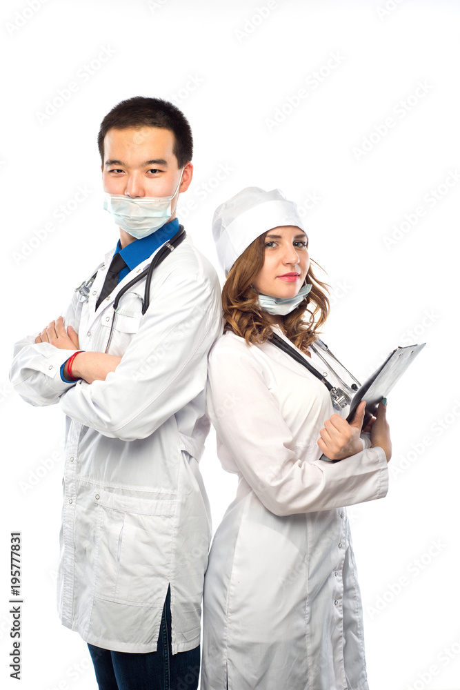 Happy team of two physicians standing back to back with arms folded isolated on white background Happy team of two physicians standing back to back with arms folded isolated on white background