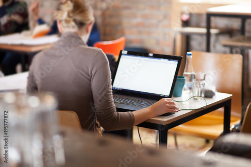 woman using laptop computer at cafe