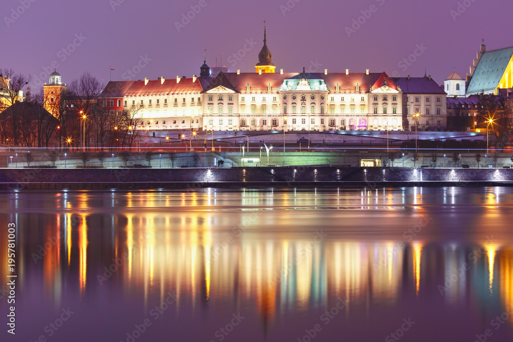 Royal Castle in Old Town with reflection in the Vistula River during evening blue hour, Warsaw, Poland.