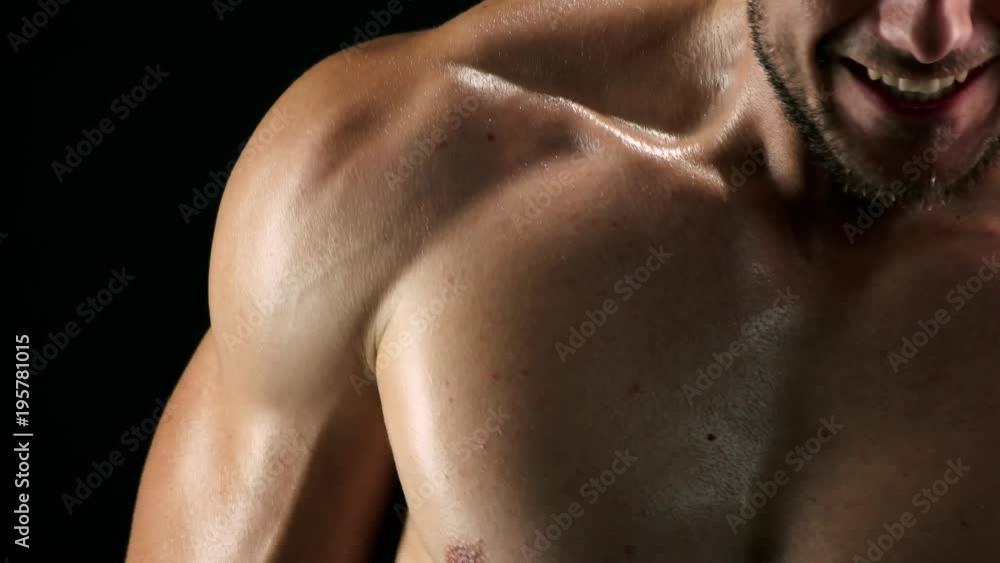 Athlete is training with maximum efforts. Close up muscular sportsman doing hard exercise with resistance band. Concept of persistence in sport. Athlete is training with maximum efforts. Close up muscular sportsman doing hard exercise with resistance band. Concept of persistence in sport.
