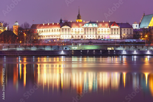 Royal Castle in Old Town with reflection in the Vistula River during evening blue hour, Warsaw, Poland.