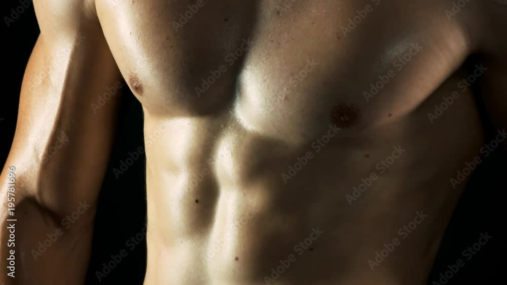 Muscular chest of young fitness man. Close up young athlete body with sexy abs. Concept of diet and training. Muscular chest of young fitness man. Close up young athlete body with sexy abs. Concept of diet and training.