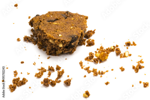 Last bite! Α bitten cookie with crumbs, isolated on white