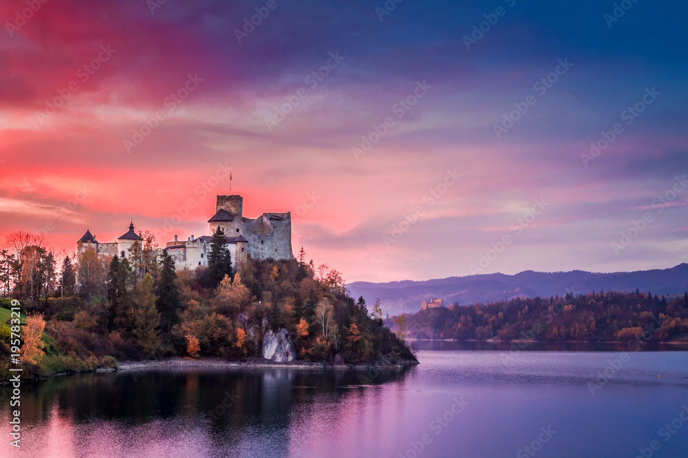 Beautiful castle by the lake at pink dusk, Poland