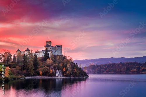 Beautiful castle by the lake at pink dusk, Poland photo