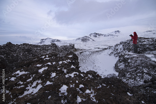 saxholl is a beautiful formed crater that erupted 3-4000 years ago in north Iceland and man photographer on top of crater.