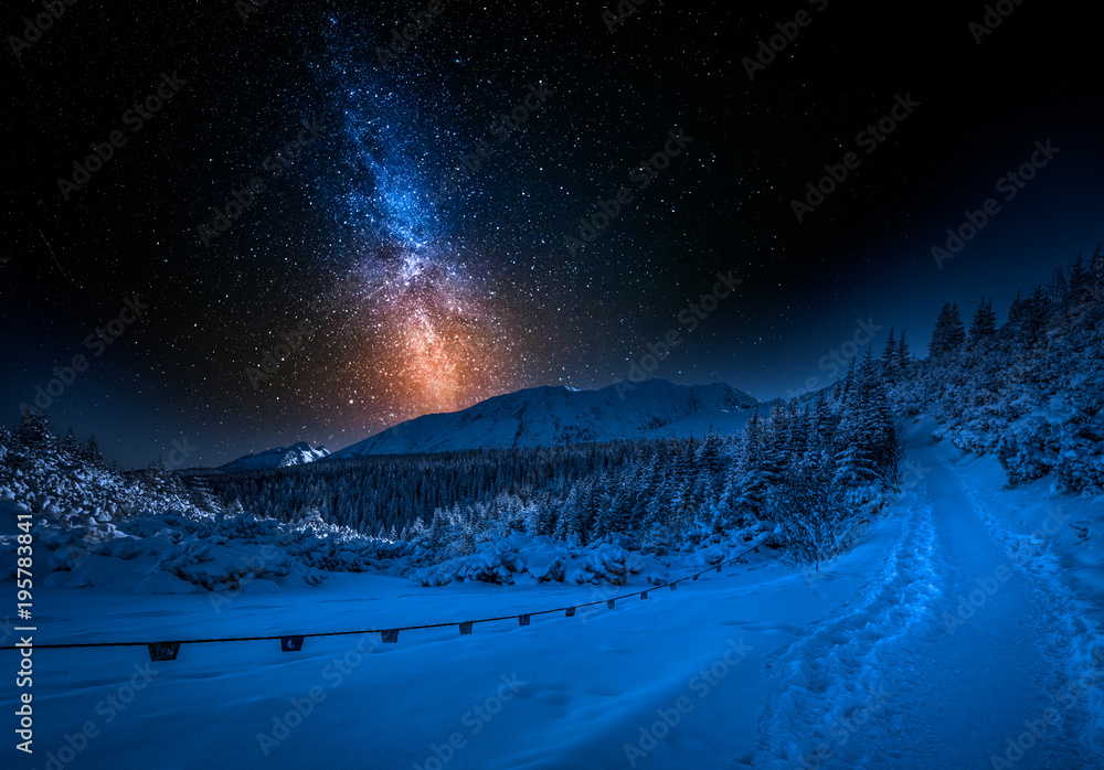 Fototapeta premium Mountain path and milky way in winter