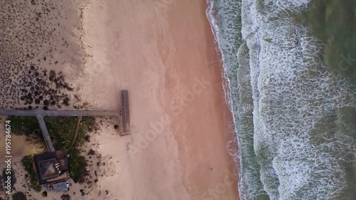 Wooden pier and waves in Quinta do Lago, Algarve, Portugal