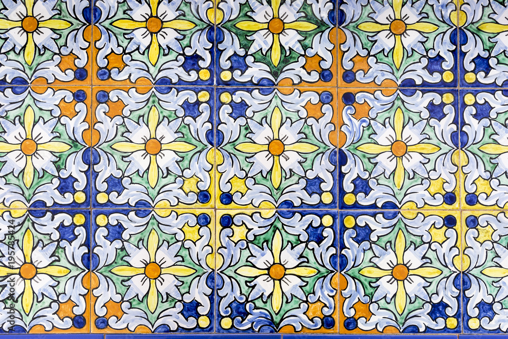 pattern of multicoloured tiles with painted flower shapes