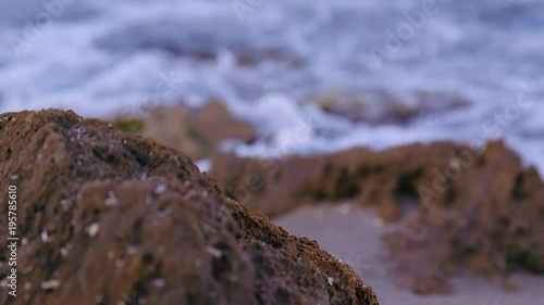 Small waves gently hitting the rocky beach 