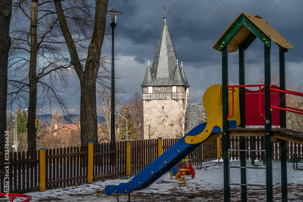 Fototapeta premium Children playground slide and Church tower