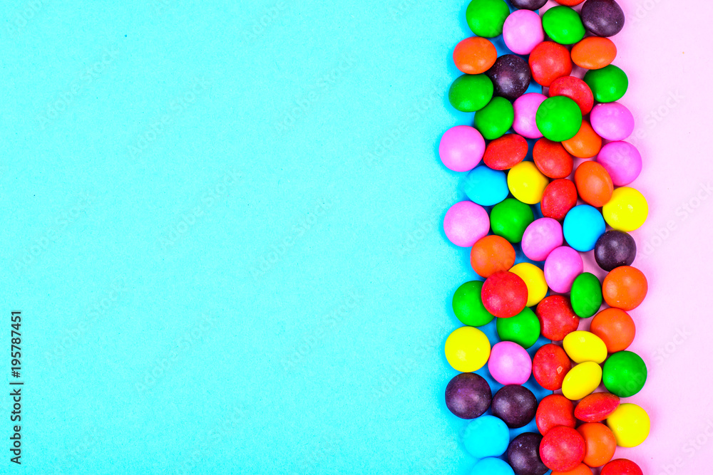 Small colored candy on bright background