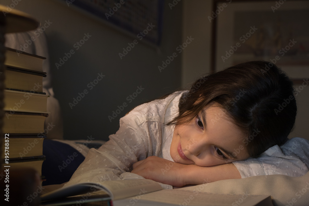 beautiful girl lies on the couch and reads an interesting book beautiful girl lies on the couch and reads an interesting book