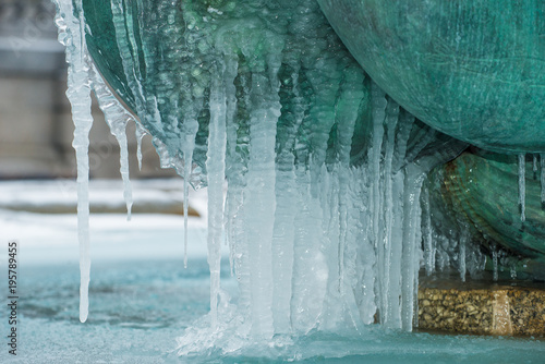 Frozen icicles on water fountain.