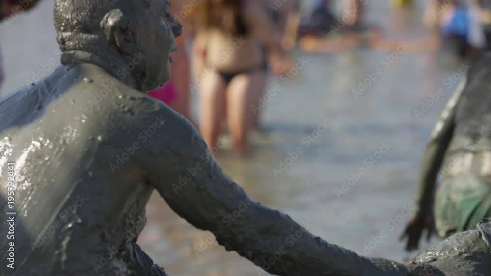 People covered in mud People covered in mud