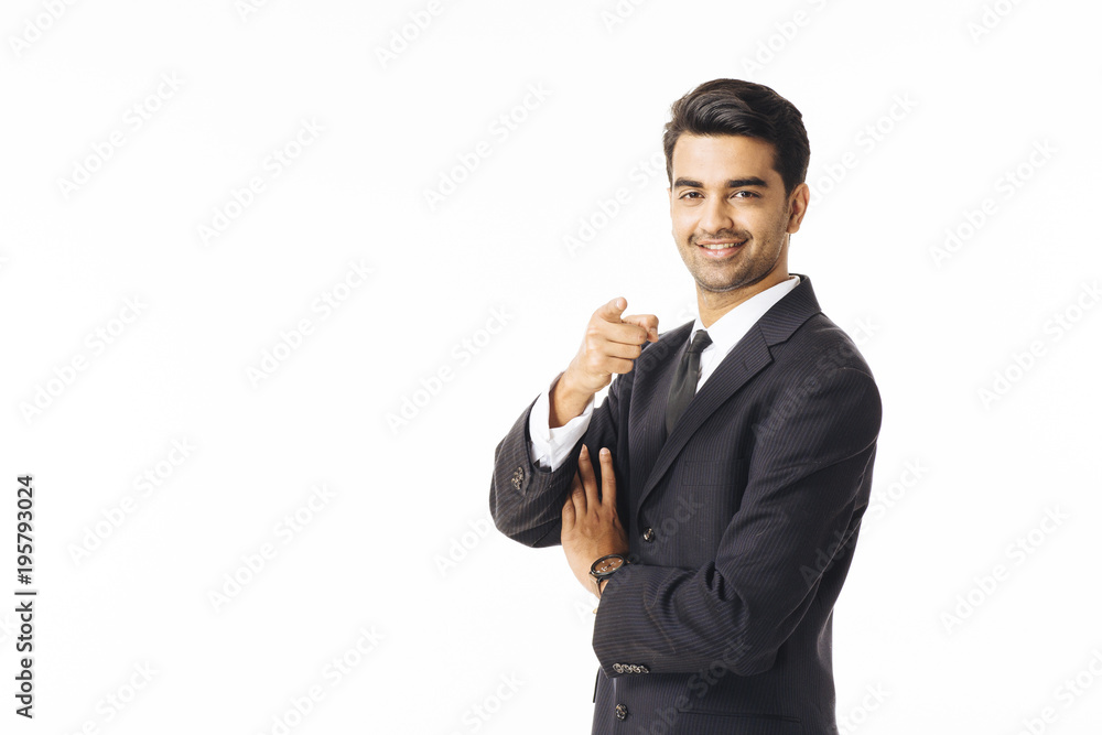 Portrait of a smiling businessman in black suit and tie pointing at camera isolated on white background Portrait of a smiling businessman in black suit and tie pointing at camera isolated on white background