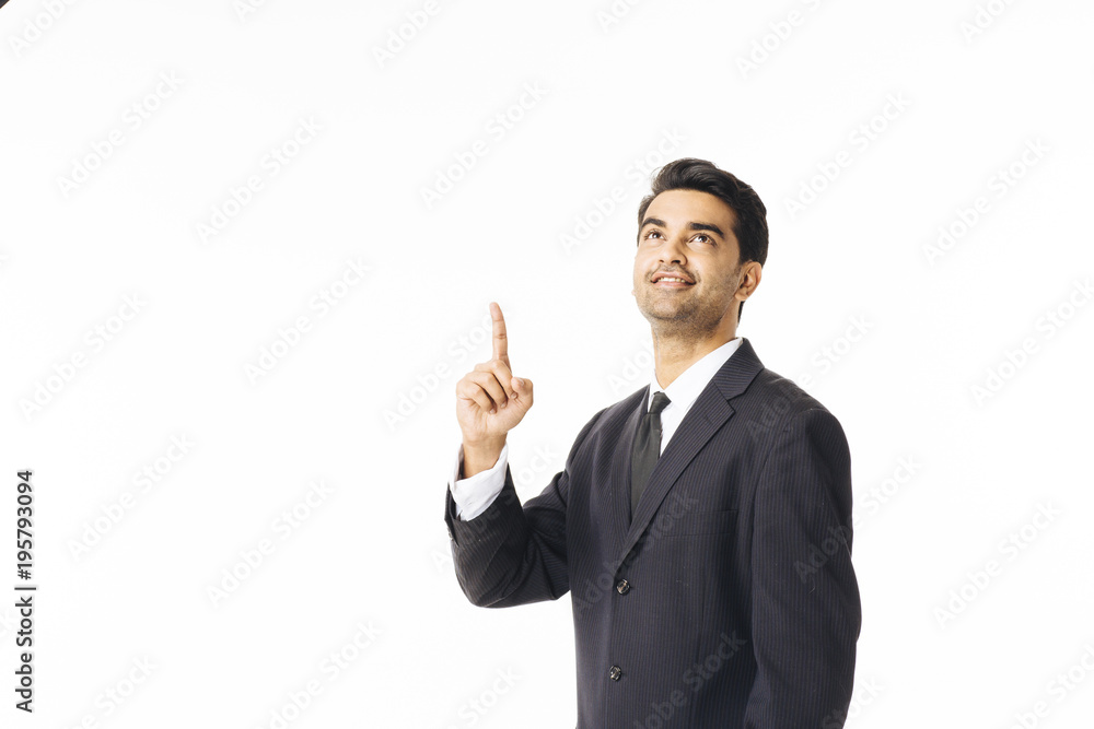 Portrait of a handsome man in business suit and tie pointing and looking up, isolated on white studio background