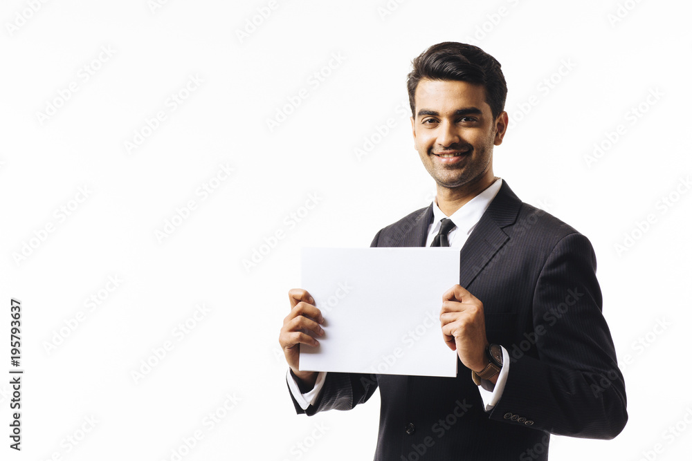 Portrait of a smiling businessman holding a blank paper card, isolated on white studio background Portrait of a smiling businessman holding a blank paper card, isolated on white studio background