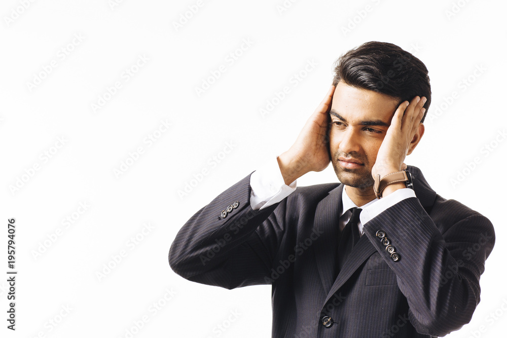 Portrait of a worried man in business suit and tie holding his head with both hands, isolated on white studio background Portrait of a worried man in business suit and tie holding his head with both hands, isolated on white studio background