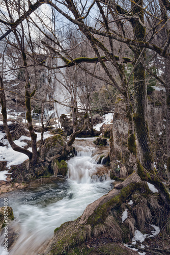 Waterfall Gostilje  Serbia at winter. Snow and ice covered hidden waterfall in the forest in winter.