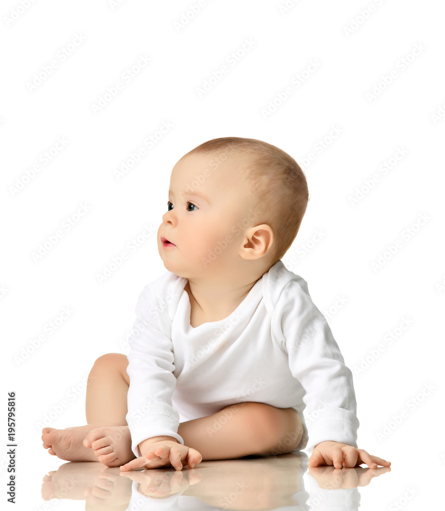 7 month infant child baby girl toddler sitting in white shirt looking at the corner 7 month infant child baby girl toddler sitting in white shirt looking at the corner
