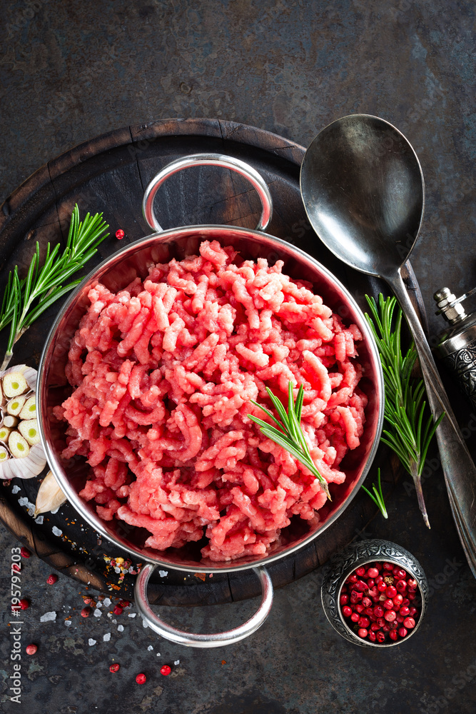 Cooking mince. Raw ground veal meat with ingredients for cooking on black kitchen table. Fresh minced meat, top view Cooking mince. Raw ground veal meat with ingredients for cooking on black kitchen table. Fresh minced meat, top view