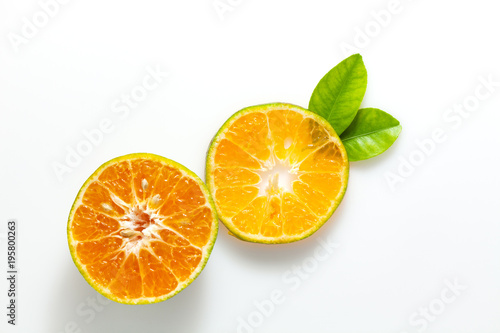 Orange fruit and leaves isolated on white background.
