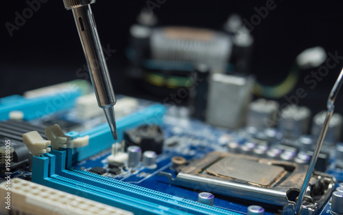 Repair of electronic devices, tin circuit with soldering iron, (spot focus)