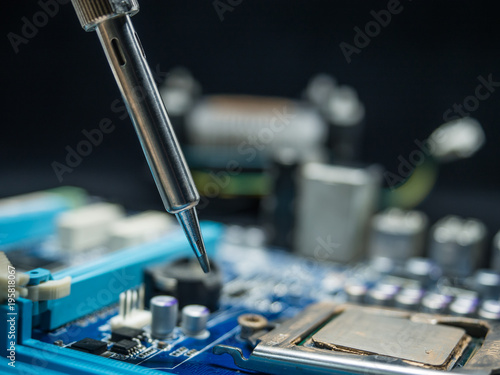 Repair of electronic devices, tin circuit with soldering iron, (spot focus)