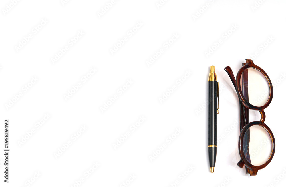 glasses and luxury pen on isolated white background with copy text space glasses and luxury pen on isolated white background with copy text space