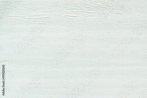 The surface texture of natural wood planks in stripes of white paint, abstract background