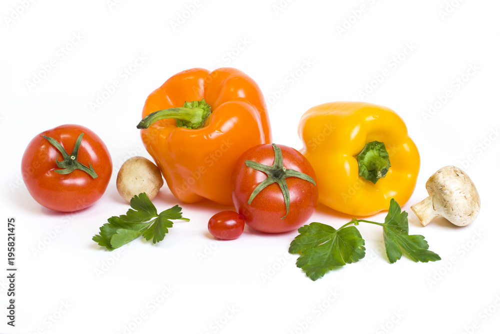 The yellow and orange peppers with tomatoes on a white background. Multicolored vegetables in a composition on a white background.. The yellow and orange peppers with tomatoes on a white background. Multicolored vegetables in a composition on a white background..