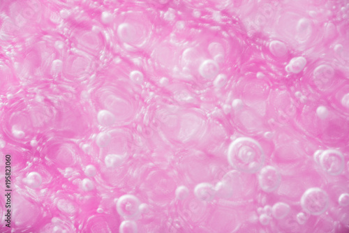Close up of Air Bubbles in Ice on Pink Background