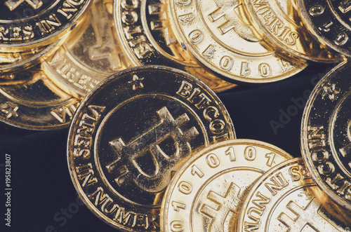 Conceptual image for worldwide cryptocurrency, huge stack physical version of golden Bitcoin