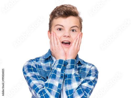 Emotional portrait of caucasian teen boy - surprised teenager looking at camera. Handsome child, isolated on white background.