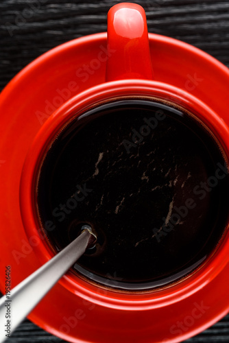 delicious coffee in a red mug on a black background